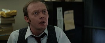 Movie still from “Blow Out” (1981), directed by Brian De Palma – A person wearing a suit and a tie; Close Up shot, Over the shoulder angle