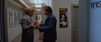 Movie still from “Blow Out” (1981), directed by Brian De Palma – A man and a woman are talking in a hallway; Medium shot, Over the shoulder angle