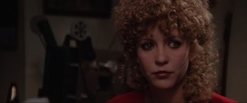 Movie still from “Blow Out” (1981), directed by Brian De Palma – A person with curly hair; Close Up shot, Over the shoulder angle