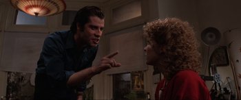 Movie still from “Blow Out” (1981), directed by Brian De Palma – A man and a woman talking to each other; Medium shot, Over the shoulder angle