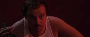 Movie still from “Blow Out” (1981), directed by Brian De Palma – A person wearing a white t - shirt; Close Up shot, Low angle