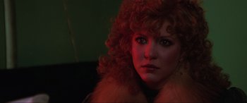 Movie still from “Blow Out” (1981), directed by Brian De Palma – A person with curly red hair; Close Up shot, Over the shoulder angle