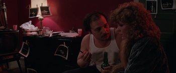 Movie still from “Blow Out” (1981), directed by Brian De Palma – A man and a woman sitting in a room with a beer; Close Up shot, Over the shoulder angle