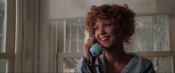 Movie still from “Blow Out” (1981), directed by Brian De Palma – A woman talking on a phone while smiling; Close Up shot, Low angle