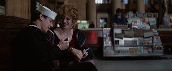 Movie still from “Blow Out” (1981), directed by Brian De Palma – A man and a woman sitting next to each other in a room; Medium shot, Over the shoulder angle