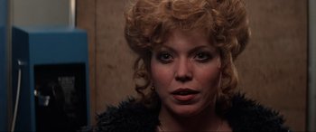 Movie still from “Blow Out” (1981), directed by Brian De Palma – A person with curly red hair; Close Up shot, Low angle