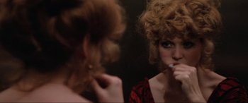 Movie still from “Blow Out” (1981), directed by Brian De Palma – A woman brushing her teeth in front of a mirror; Close Up shot, Over the shoulder angle
