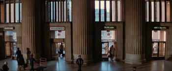 Movie still from “Blow Out” (1981), directed by Brian De Palma – A man standing in front of a tall pillar; Extreme Wide shot, High angle