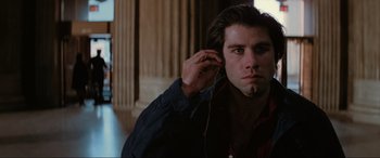 Movie still from “Blow Out” (1981), directed by Brian De Palma – A young man listening to music on a pair of headphones; Close Up shot, Low angle