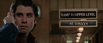 Movie still from “Blow Out” (1981), directed by Brian De Palma – A person standing in front of a sign; Close Up shot, Low angle