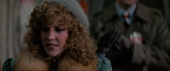 Movie still from “Blow Out” (1981), directed by Brian De Palma – A person with curly hair wearing a hat; Close Up shot, Over the shoulder angle