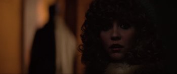 Movie still from “Blow Out” (1981), directed by Brian De Palma – A person with curly black hair; Close Up shot, Over the shoulder angle