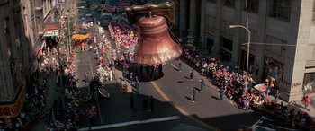 Movie still from “Blow Out” (1981), directed by Brian De Palma – A large bell balloon being carried down a street; Extreme Wide shot, Overhead angle