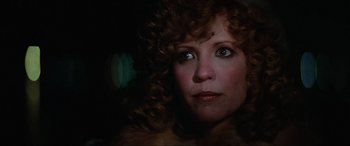 Movie still from “Blow Out” (1981), directed by Brian De Palma – A person with curly red hair; Close Up shot, Low angle