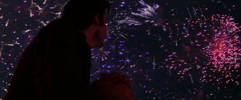 Movie still from “Blow Out” (1981), directed by Brian De Palma – A man and a woman looking at fireworks in the night sky; Close Up shot, Low angle