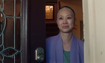 A woman standing in front of an open door