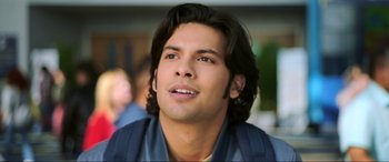 Movie still from “Blue Beetle” (2023), directed by Angel Manuel Soto – A person with long hair; Close Up shot, Low angle