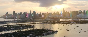 Movie still from “Blue Beetle” (2023), directed by Angel Manuel Soto – A view of a city from above at sunset; Extreme Wide shot, High angle