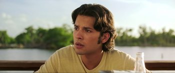 Movie still from “Blue Beetle” (2023), directed by Angel Manuel Soto – A person with long brown hair; Close Up shot, Over the shoulder angle