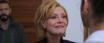 Movie still from “Blue Beetle” (2023), directed by Angel Manuel Soto – A person wearing a jacket; Close Up shot, Over the shoulder angle