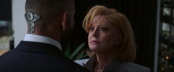 Movie still from “Blue Beetle” (2023), directed by Angel Manuel Soto – An older woman with blonde hair looking at a younger man; Close Up shot, Over the shoulder angle