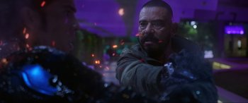 Movie still from “Blue Beetle” (2023), directed by Angel Manuel Soto – A man with a beard is looking at another man with a beard; Close Up shot, Over the shoulder angle