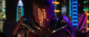 Movie still from “Blue Beetle” (2023), directed by Angel Manuel Soto – A person's face in a purple helmet; Close Up shot, Low angle