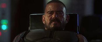 Movie still from “Blue Beetle” (2023), directed by Angel Manuel Soto – A person with a beard; Close Up shot, Low angle