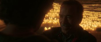 Movie still from “Blue Beetle” (2023), directed by Angel Manuel Soto – An older man is looking at the lights; Close Up shot, Over the shoulder angle