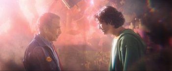 Movie still from “Blue Beetle” (2023), directed by Angel Manuel Soto – Two men are facing each other in a room; Medium shot, Over the shoulder angle