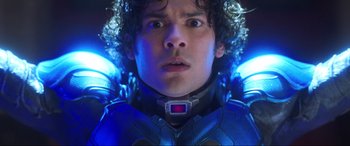 Movie still from “Blue Beetle” (2023), directed by Angel Manuel Soto – A person wearing a suit; Close Up shot, Low angle