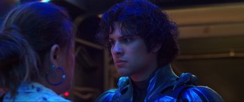 Movie still from “Blue Beetle” (2023), directed by Angel Manuel Soto – A person with curly hair; Close Up shot, Over the shoulder angle