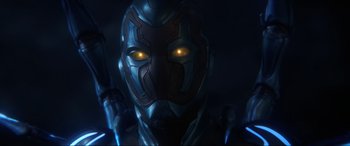 Movie still from “Blue Beetle” (2023), directed by Angel Manuel Soto – The face of a man with a gun; Close Up shot, Low angle