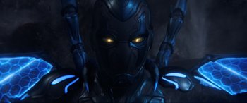 Movie still from “Blue Beetle” (2023), directed by Angel Manuel Soto – The face of an iron man character; Close Up shot, Low angle