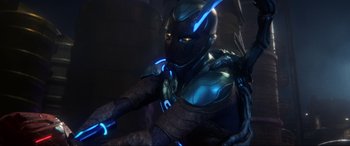 Movie still from “Blue Beetle” (2023), directed by Angel Manuel Soto – A person wearing a costume; Medium shot, Low angle