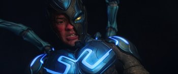 Movie still from “Blue Beetle” (2023), directed by Angel Manuel Soto – A person wearing a costume; Close Up shot, Low angle