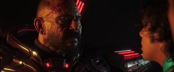 Movie still from “Blue Beetle” (2023), directed by Angel Manuel Soto – A man's face in a dark room; Close Up shot, Low angle