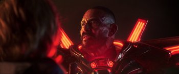 Movie still from “Blue Beetle” (2023), directed by Angel Manuel Soto – A person wearing a helmet; Close Up shot, Over the shoulder angle