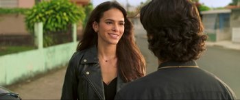 Movie still from “Blue Beetle” (2023), directed by Angel Manuel Soto – A woman in a leather jacket talking to another woman; Close Up shot, Over the shoulder angle