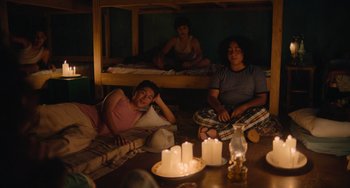 Movie still from “Blue Miracle” (2021), directed by Julio Quintana – A group of people sitting on top of bunkbeds in a room; Wide shot, High angle