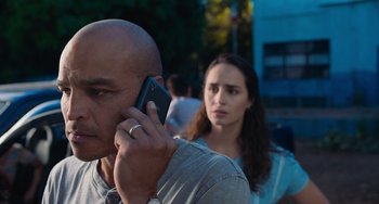 Movie still from “Blue Miracle” (2021), directed by Julio Quintana – A man and a woman on a cell phone; Close Up shot, Low angle