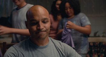 Movie still from “Blue Miracle” (2021), directed by Julio Quintana – A man with a bald head is looking at the camera; Close Up shot, Over the shoulder angle