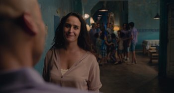 Movie still from “Blue Miracle” (2021), directed by Julio Quintana – A woman standing next to a group of people; Medium shot, Over the shoulder angle