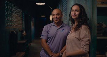 Movie still from “Blue Miracle” (2021), directed by Julio Quintana – A man and a woman posing for a picture; Medium shot, Low angle