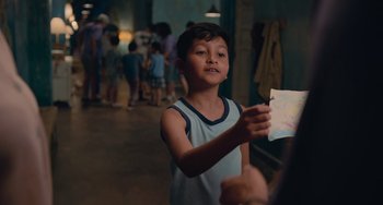 Movie still from “Blue Miracle” (2021), directed by Julio Quintana – A young boy is holding a piece of paper; Close Up shot, Over the shoulder angle
