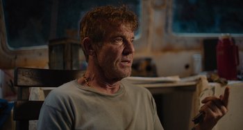 Movie still from “Blue Miracle” (2021), directed by Julio Quintana – A person wearing a necklace; Close Up shot, Over the shoulder angle