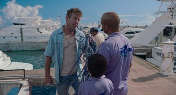 Movie still from “Blue Miracle” (2021), directed by Julio Quintana – Two men and a boy are talking to each other; Medium shot, Over the shoulder angle