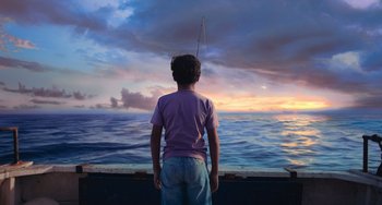 Movie still from “Blue Miracle” (2021), directed by Julio Quintana – A boy standing on the deck of a boat looking out at the ocean; Wide shot, Low angle