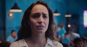 Movie still from “Blue Miracle” (2021), directed by Julio Quintana – A person wearing a white and black shirt; Close Up shot, Over the shoulder angle