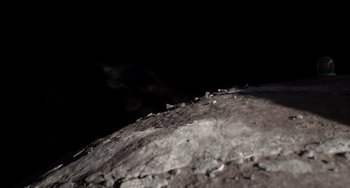 Movie still from “Blush” (2021), directed by Joe Mateo – A view of the moon's surface at night from the ground; Extreme Wide shot, Overhead angle